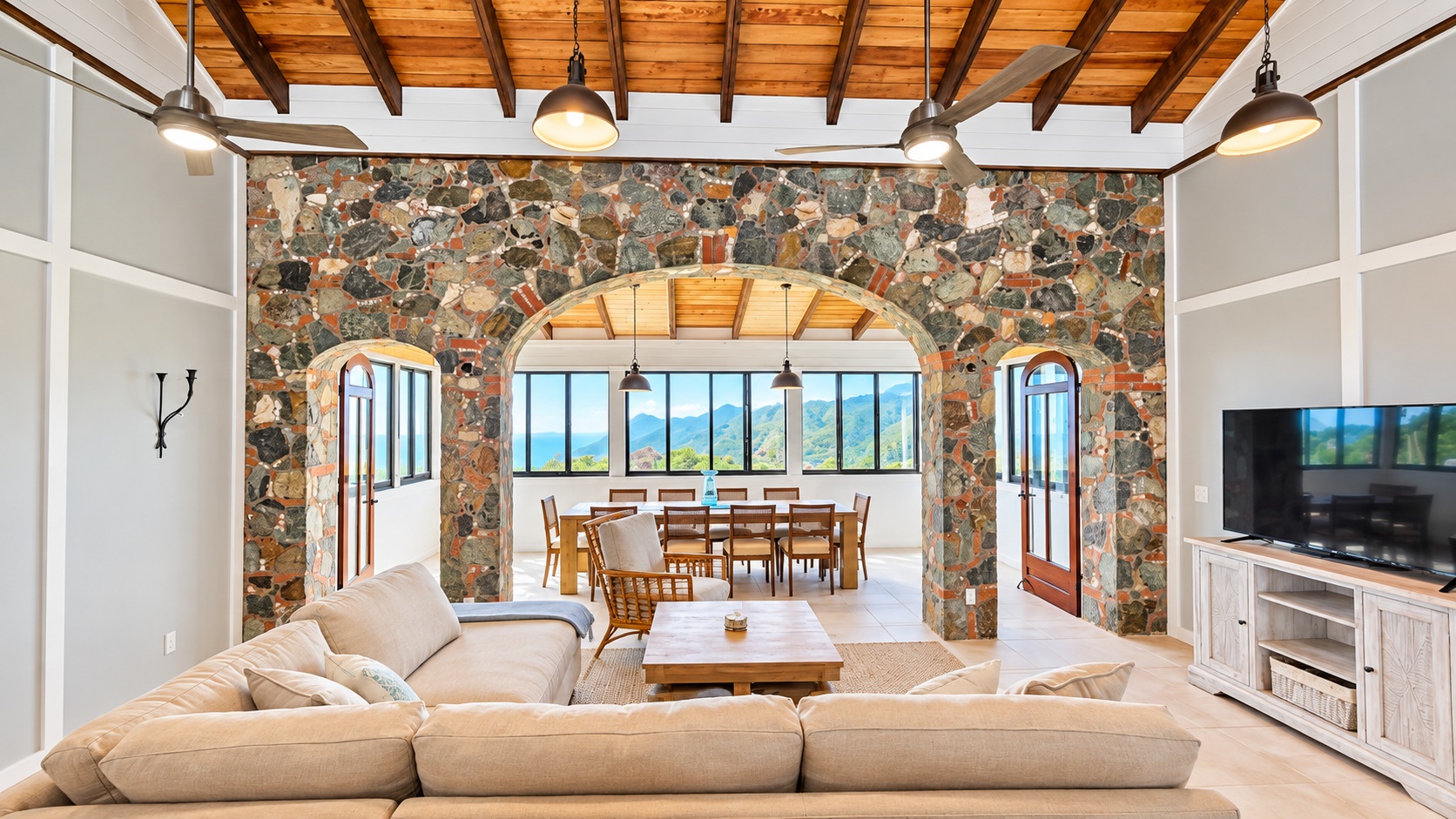 Bright living and dining room with stone arches at Beyond A Dream